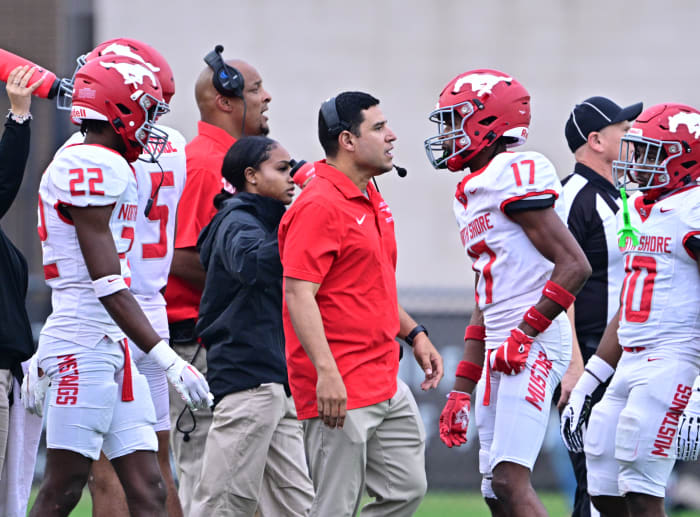 North Shore players, coaches meet on the sideline during a 6A Division I state semifinal win over Westlake on December 9.